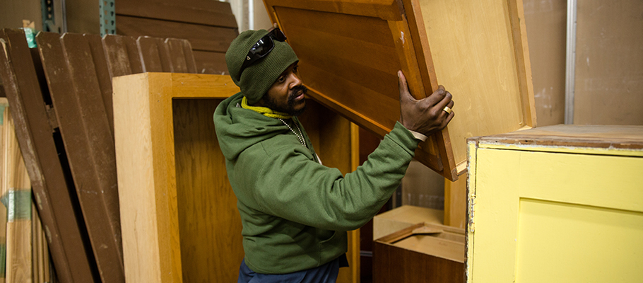 Person carrying a cabinet