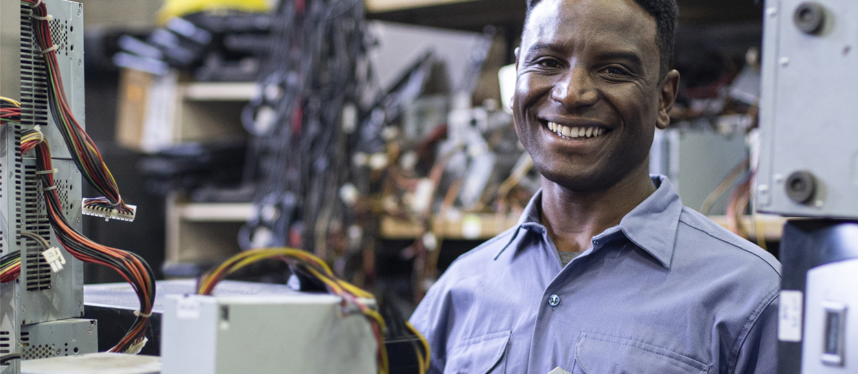 Man smiling with electronics