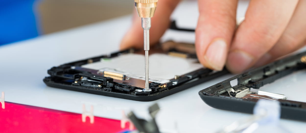 Close up of hands repairing phone