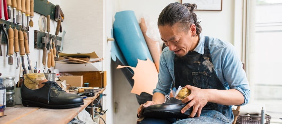 Cobbler repairing a shoe