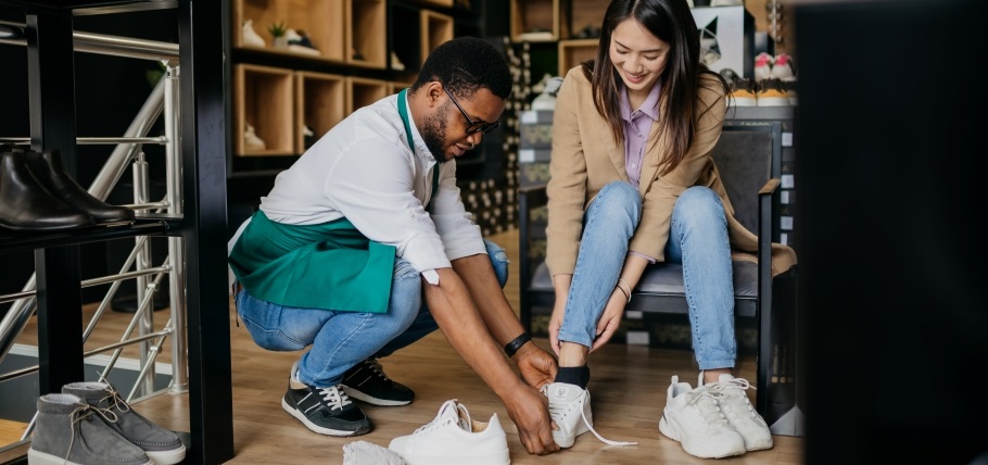 Woman trying on a new pair of shoes at the store