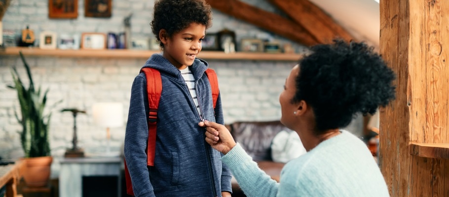 Mom zipping son's jacket