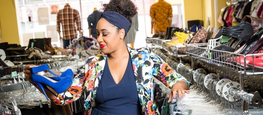 Woman shopping for high heels in thrift store