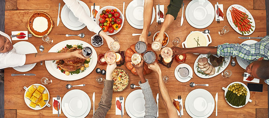 Image from above table where guests clink glasses