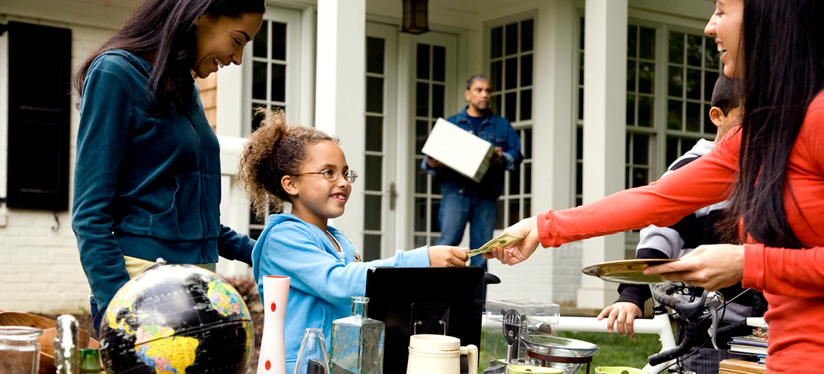 Young girl buying item from garage sale