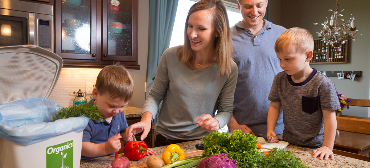 Family composting in their kitchen